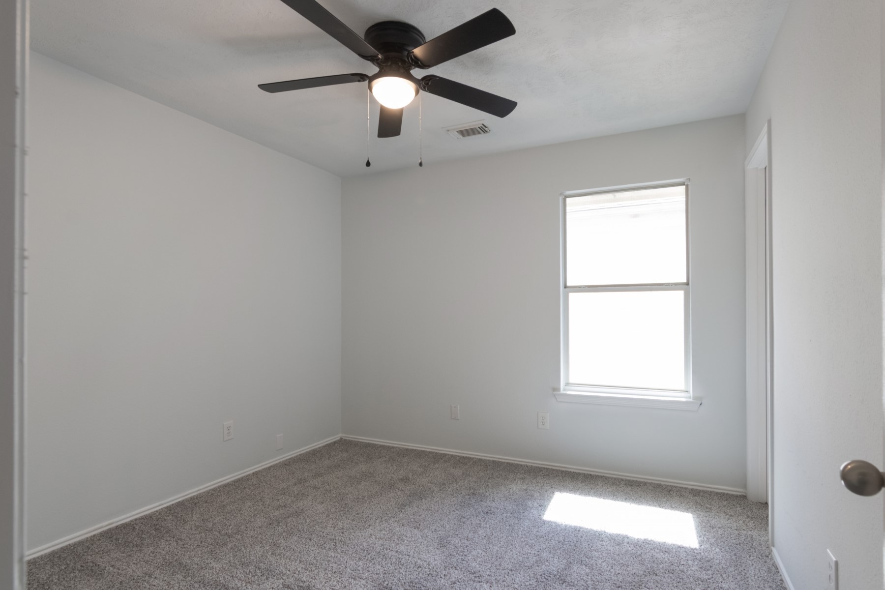 5326 Coast Line Street Baytown, TX 77521 - Photo 19 of 26 an empty room with a window and a fan
