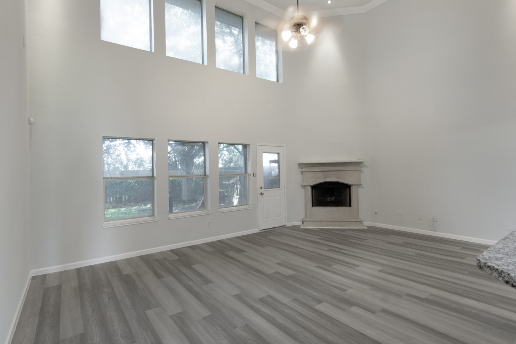 5326 Coast Line Street Baytown, TX 77521 - Photo 6 of 26 a view of an empty room with wooden floor and a window