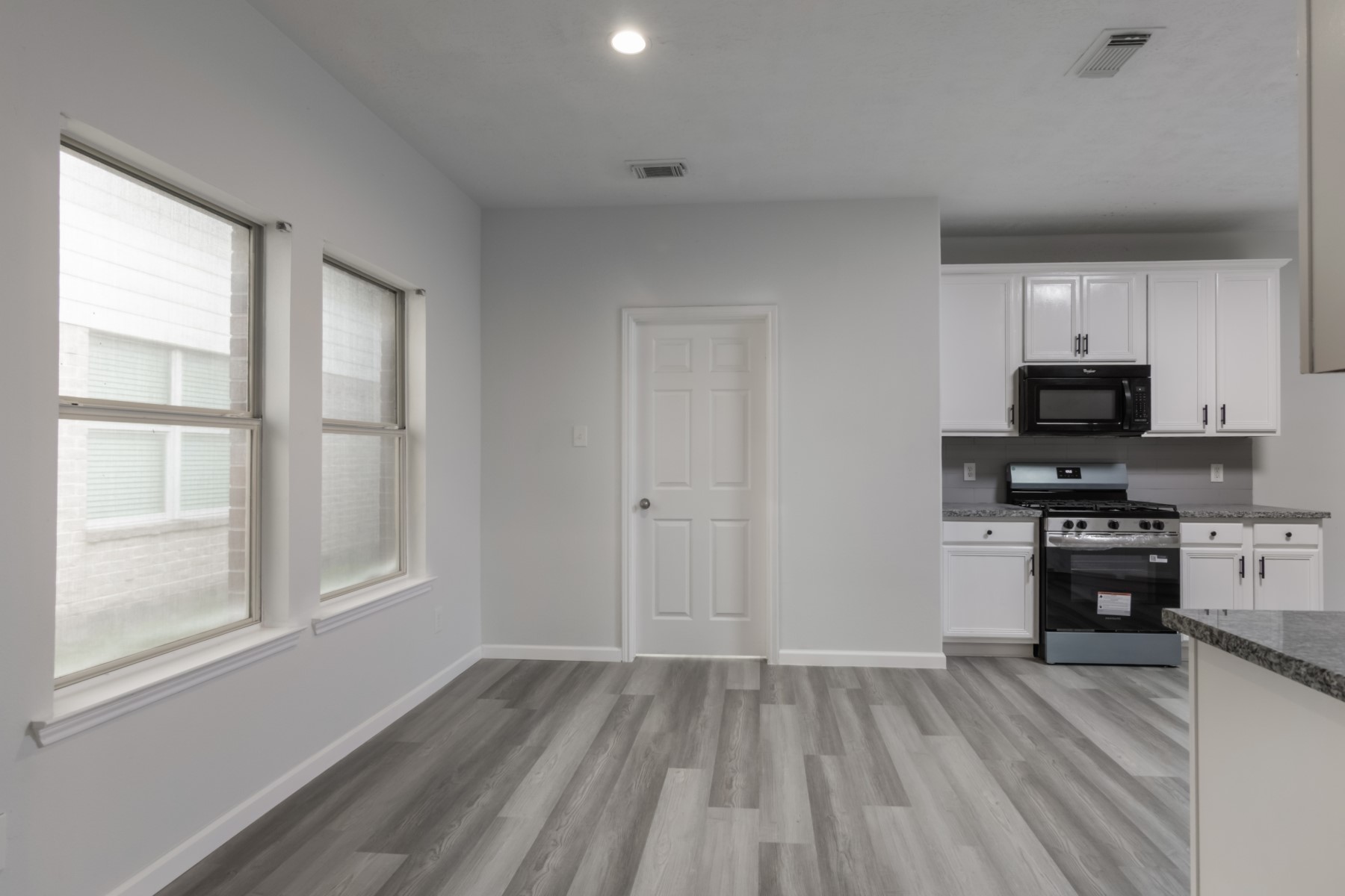 5326 Coast Line Street Baytown, TX 77521 - Photo 7 of 26 a kitchen with wooden floors and appliances