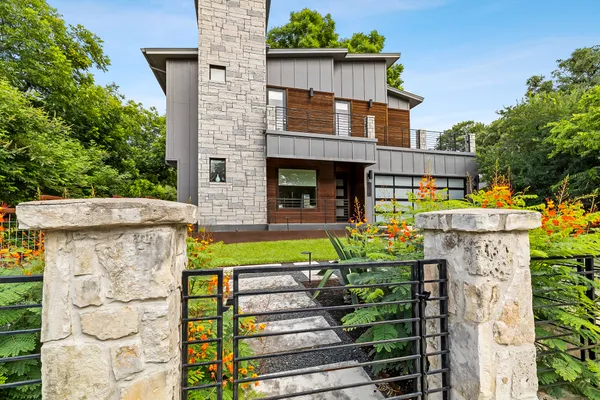 a view of a house with wooden fence