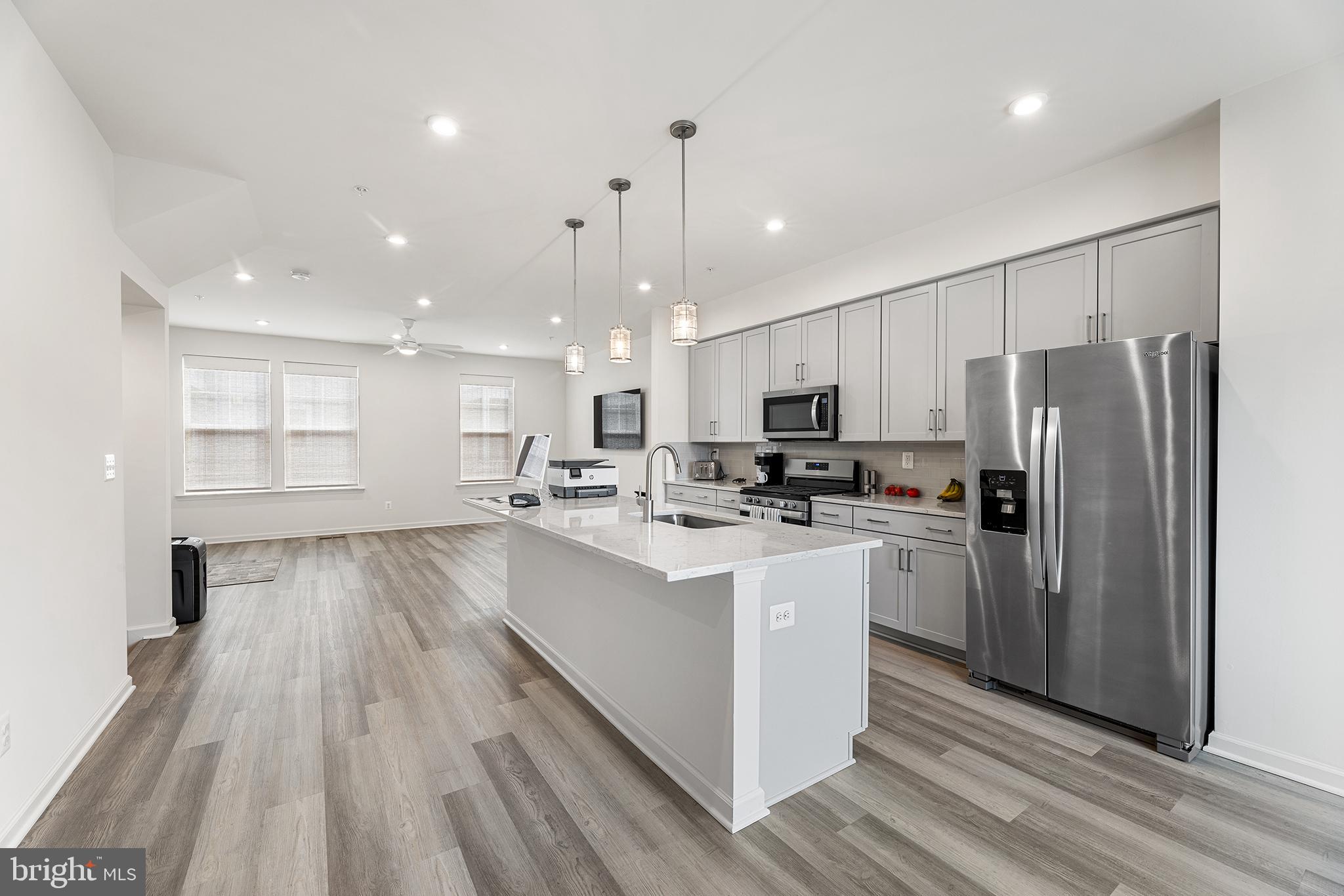 520 Marshy Cove, Unit 163 Cambridge, MD 21613 - Photo 13 of 42 a kitchen with refrigerator cabinets and wooden floor