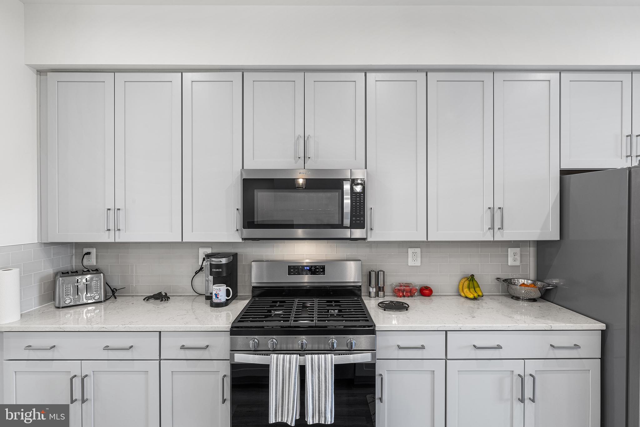 520 Marshy Cove, Unit 163 Cambridge, MD 21613 - Photo 15 of 42 a kitchen with white cabinets and appliances