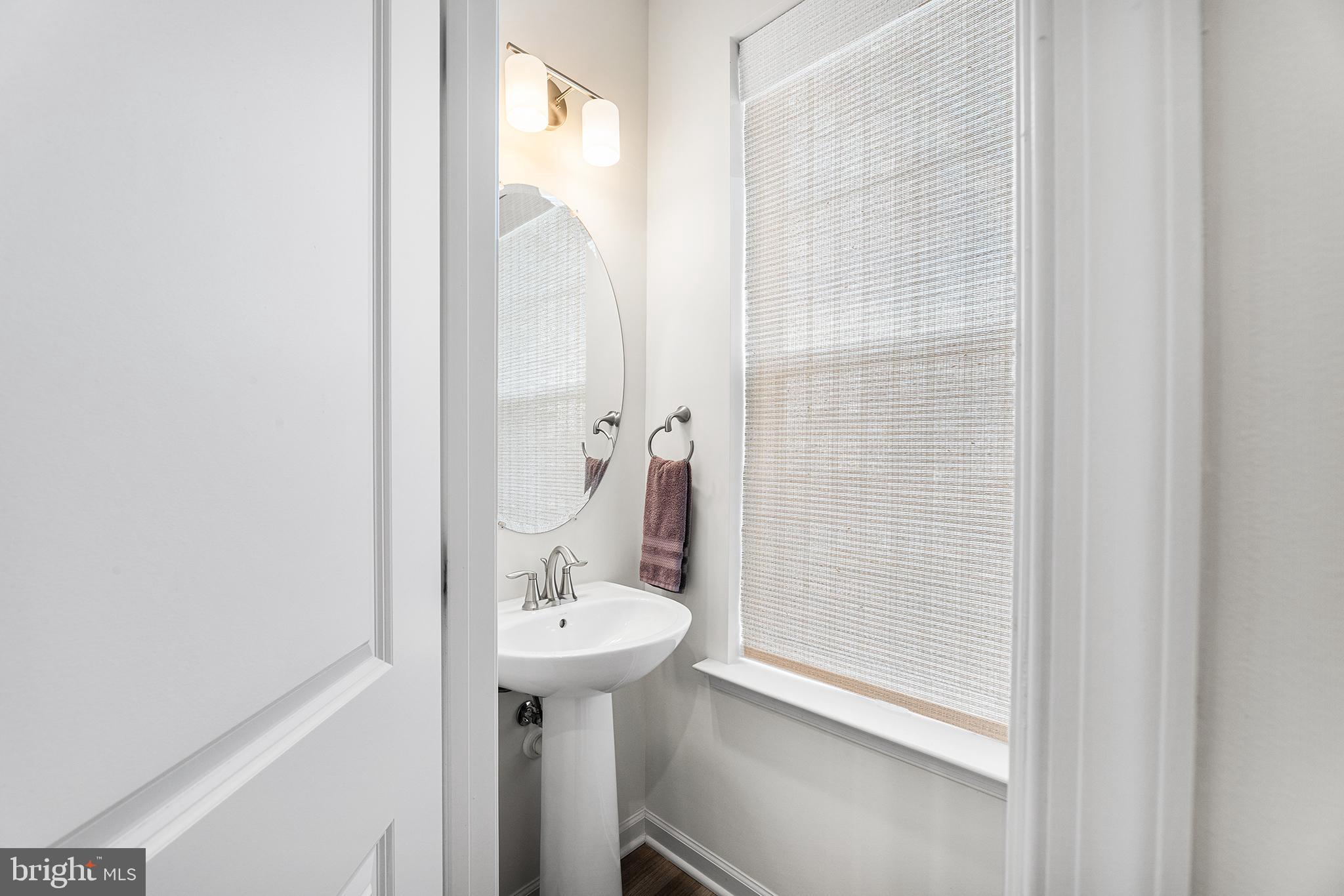 520 Marshy Cove, Unit 163 Cambridge, MD 21613 - Photo 20 of 42 a bathroom with a sink and a mirror