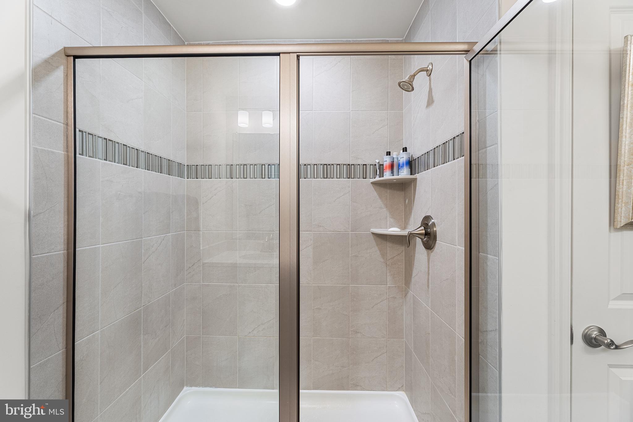 520 Marshy Cove, Unit 163 Cambridge, MD 21613 - Photo 23 of 42 a bathroom with a shower and a sink