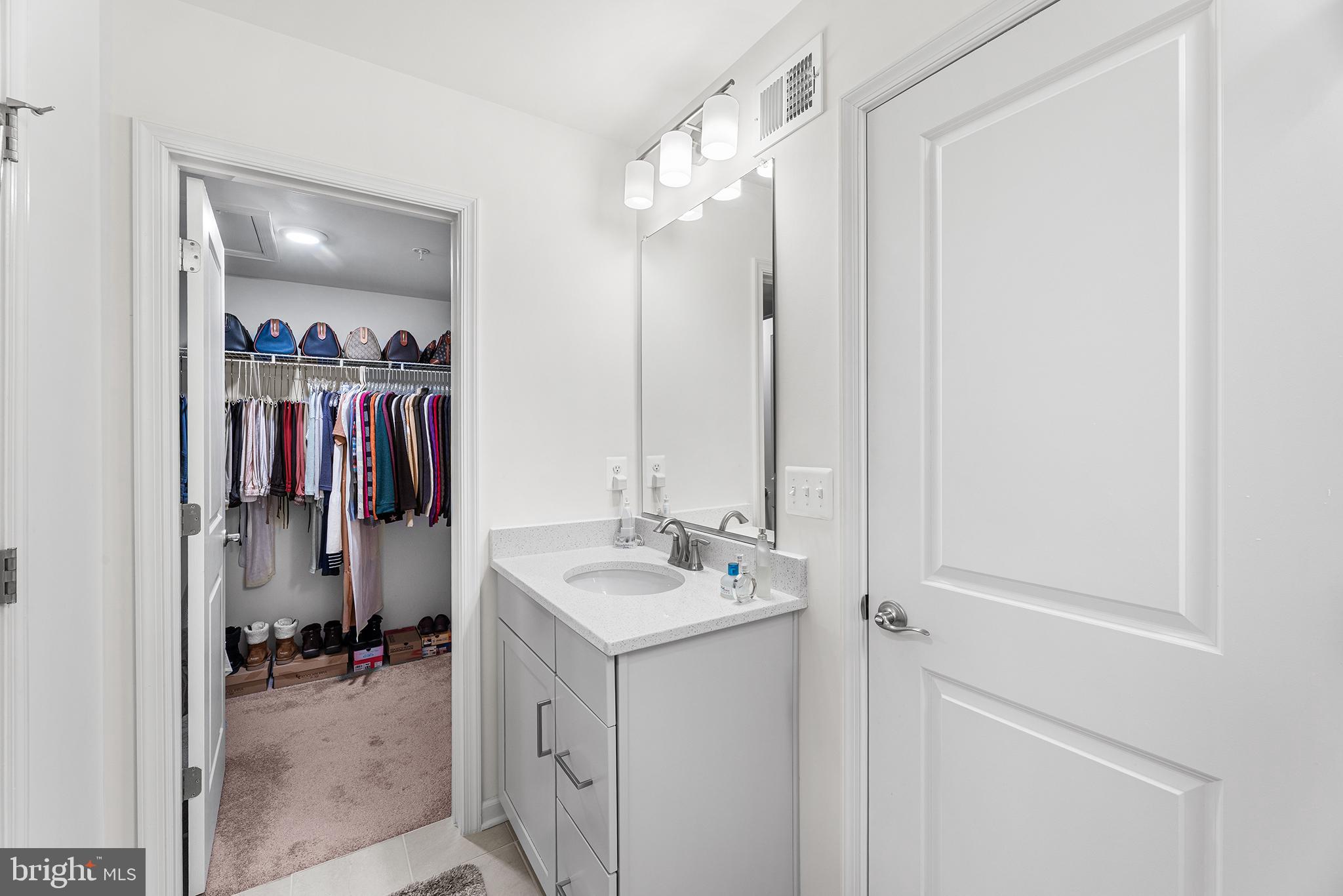 520 Marshy Cove, Unit 163 Cambridge, MD 21613 - Photo 24 of 42 a bathroom with a sink vanity and a mirror