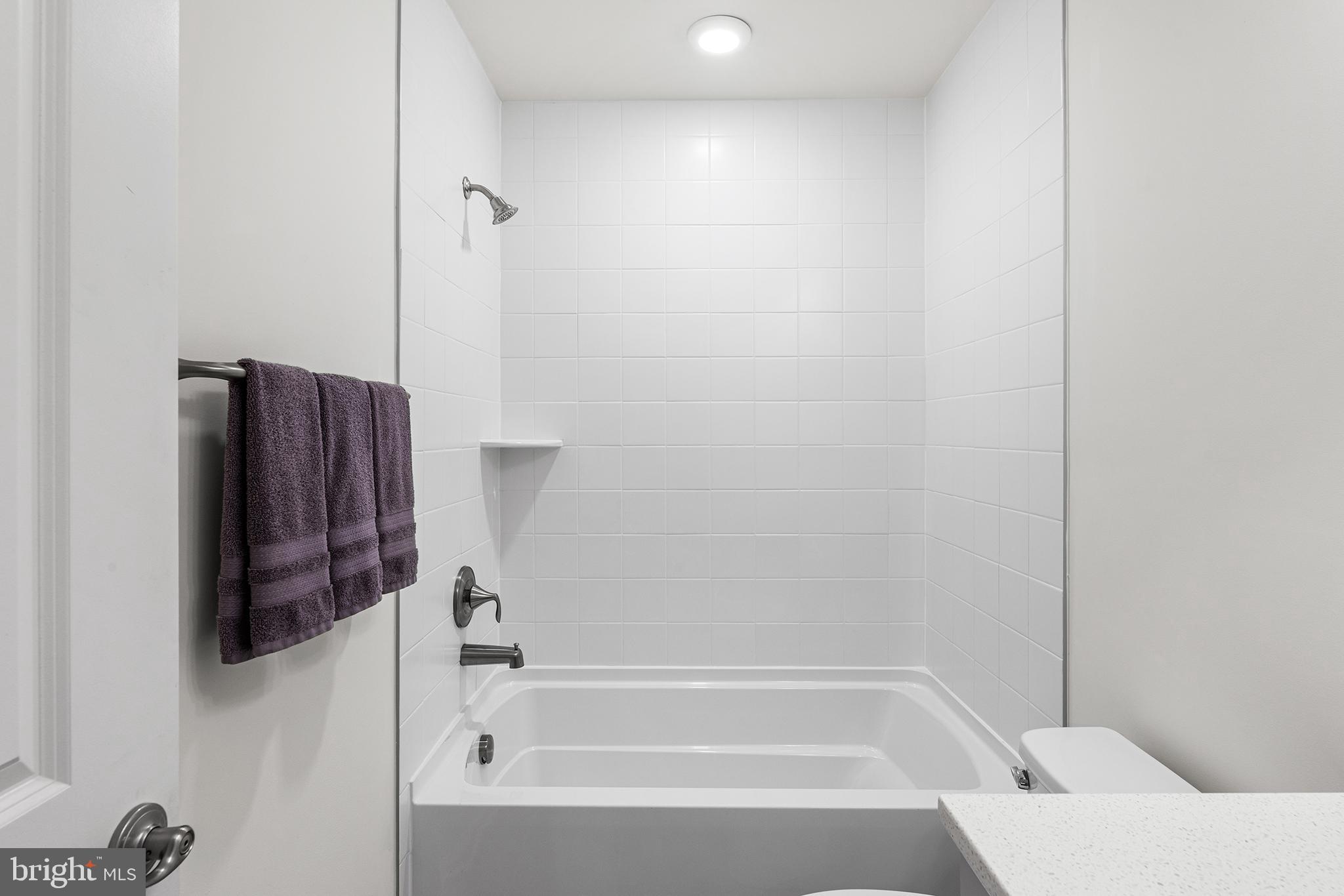 520 Marshy Cove, Unit 163 Cambridge, MD 21613 - Photo 31 of 42 a bathroom with a bathtub and a shower