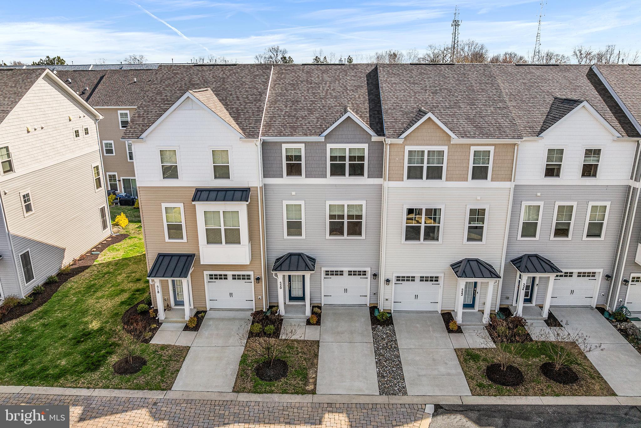 520 Marshy Cove, Unit 163 Cambridge, MD 21613 - Photo 4 of 42 a view of a white house with large windows next to a yard