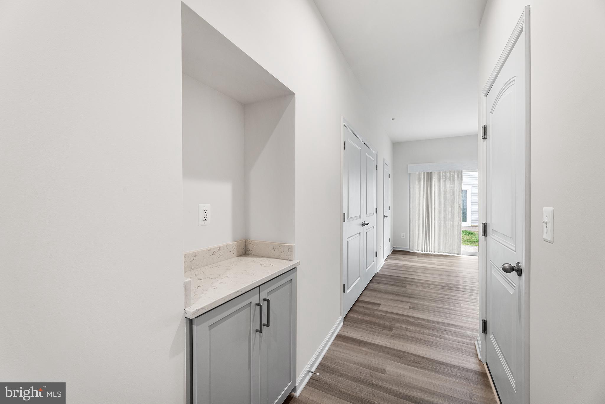 520 Marshy Cove, Unit 163 Cambridge, MD 21613 - Photo 8 of 42 a view of a hallway with wooden floor and staircase