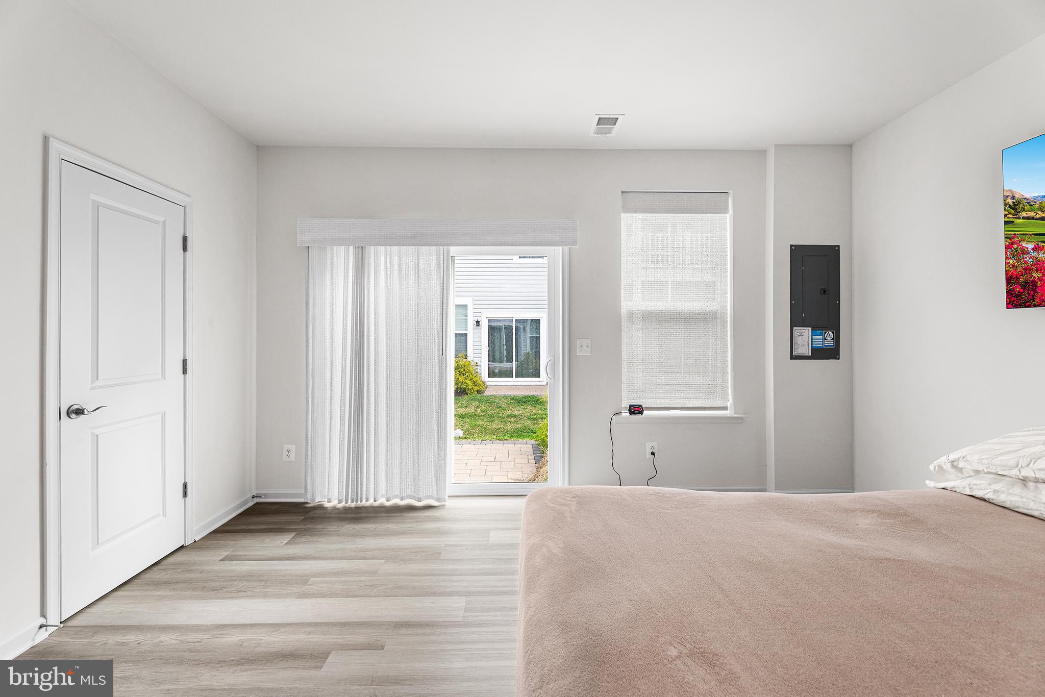 520 Marshy Cove, Unit 163 Cambridge, MD 21613 - Photo 10 of 42 a view of a bedroom with wooden floor and windows