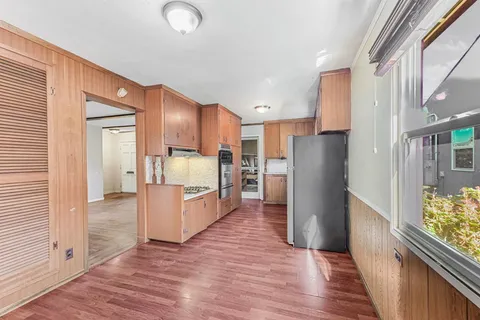 a view of an empty room with wooden floor
