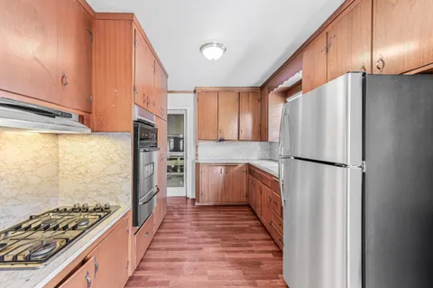 a view of a bedroom with wooden floor and closet