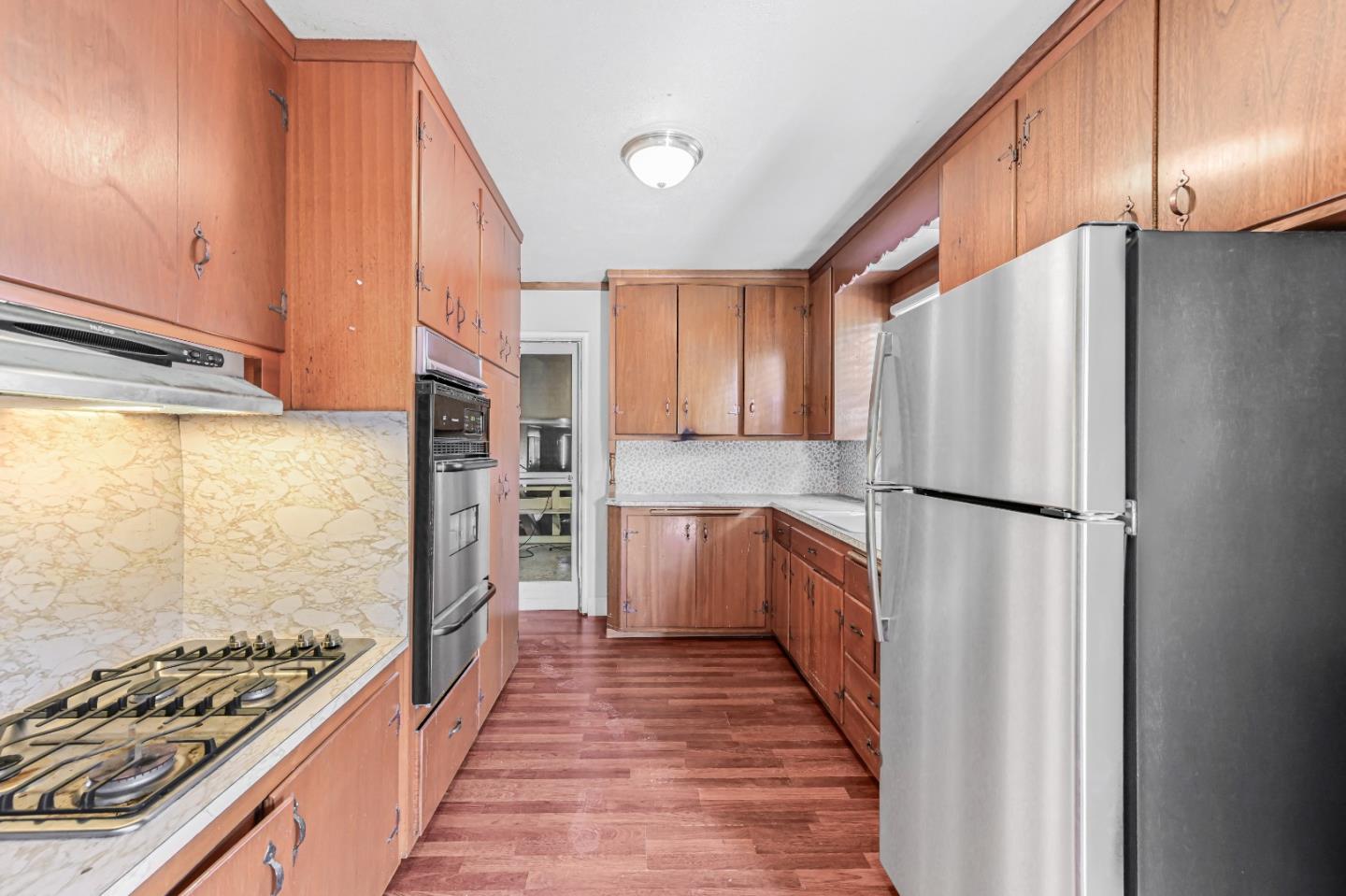 2537 Lessley Avenue Castro Valley, CA 94546 - Photo 6 of 14 a kitchen with stainless steel appliances a refrigerator a stove and wooden cabinets