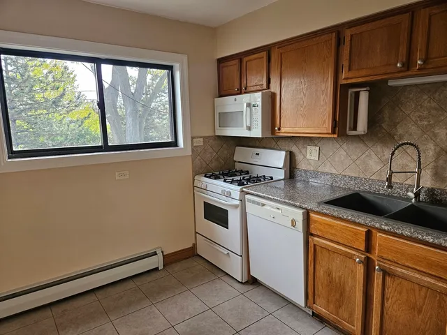a kitchen with stainless steel appliances granite countertop a sink stove and microwave