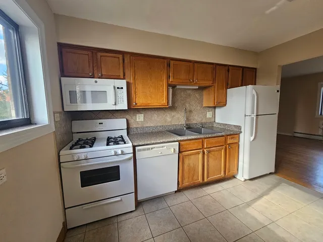 a kitchen with a stove top oven sink and refrigerator