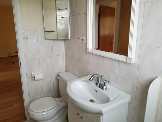 a bathroom with a sink a mirror and toilet