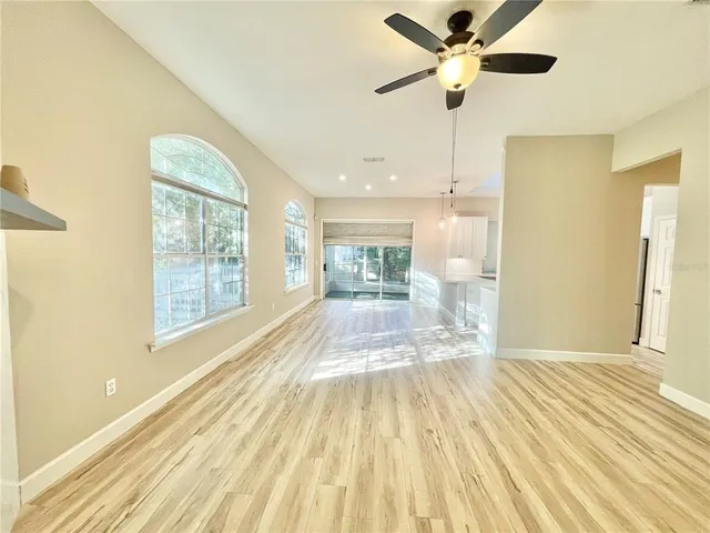 a view of empty room with wooden floor
