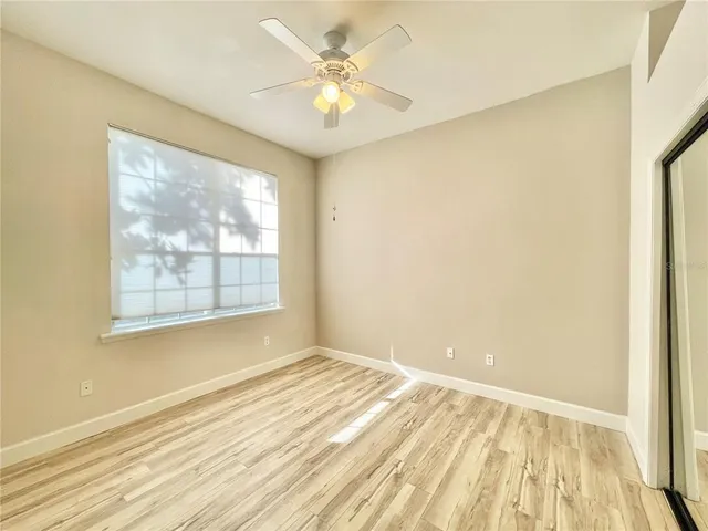 a view of an empty room with a ceiling fan