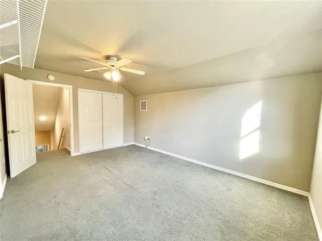 a view of room with window and ceiling fan