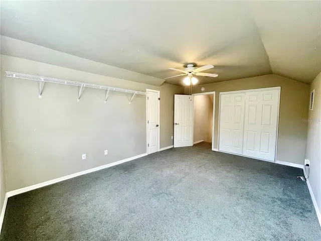 a view of a house with wooden deck and furniture