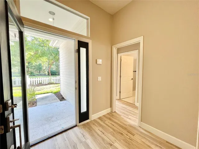 a view of a patio with a table chairs and a fire pit