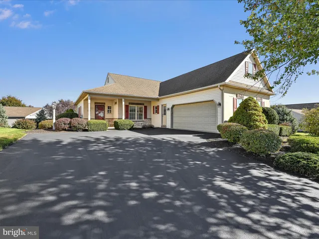 a front view of a house with a yard and outdoor seating