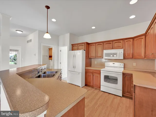 a kitchen with refrigerator cabinets and a sink
