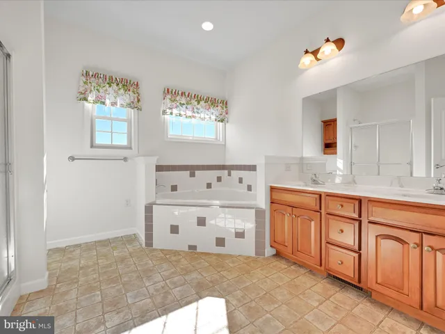 a spacious bathroom with a granite countertop sink a mirror and a