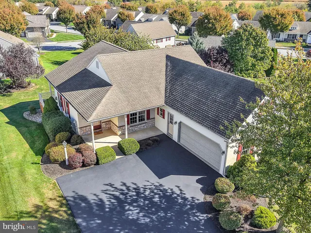 an aerial view of a house with a yard basket ball court and outdoor seating
