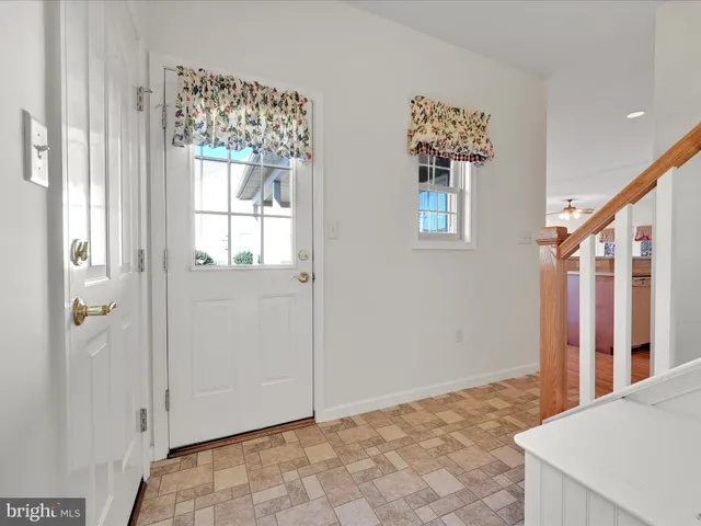 a view of an entryway with wooden floor
