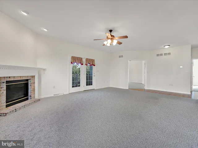 a view of empty room with a fireplace