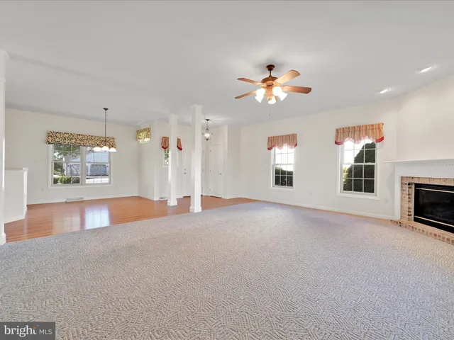 a view of empty room with fireplace and fan