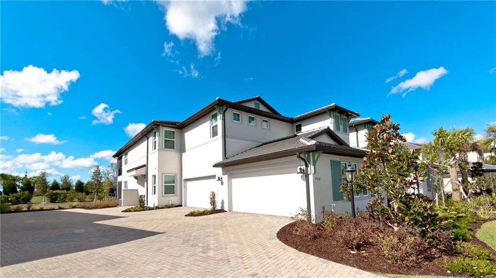7530 Divot Loop, Unit 3A Lakewood Ranch, FL 34202 - Photo 1 of 1 a view of a house with a street