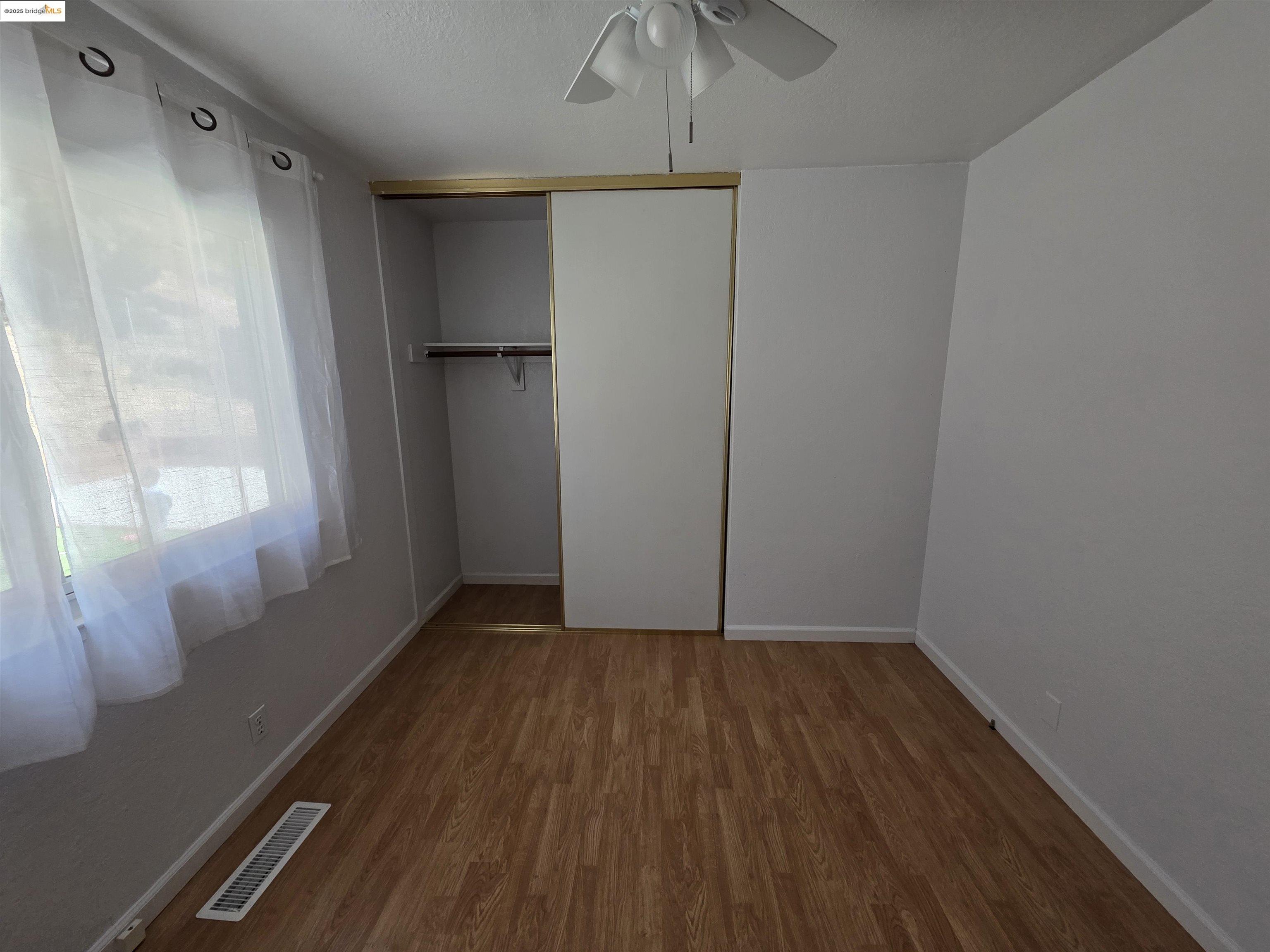 136 Evergreen Way Vallejo, CA 94591 - Photo 18 of 51 a view of an empty room with wooden floor and a window