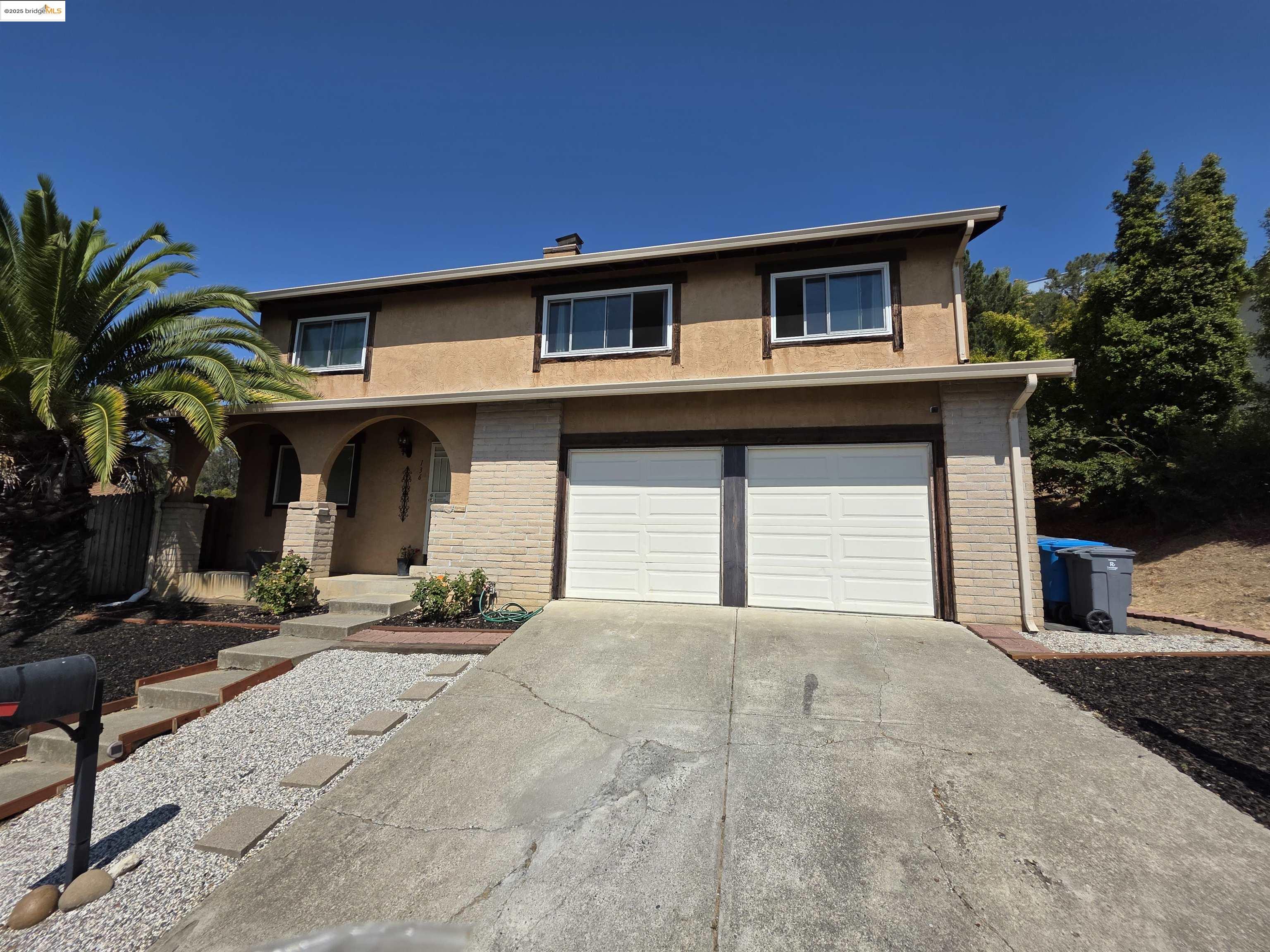 136 Evergreen Way Vallejo, CA 94591 - Photo 30 of 51 a front view of a house with a yard and garage