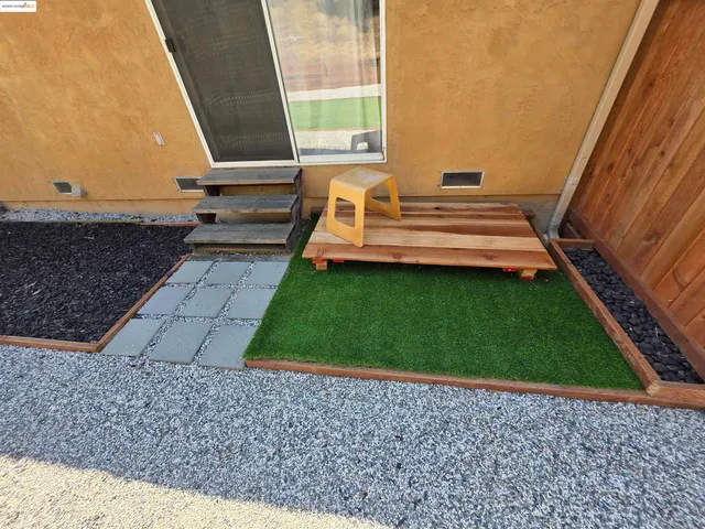 a view of a backyard with wooden fence