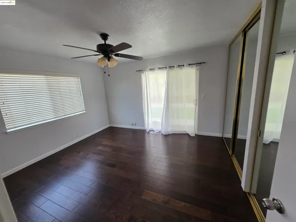 a view of a livingroom with wooden floor and a window