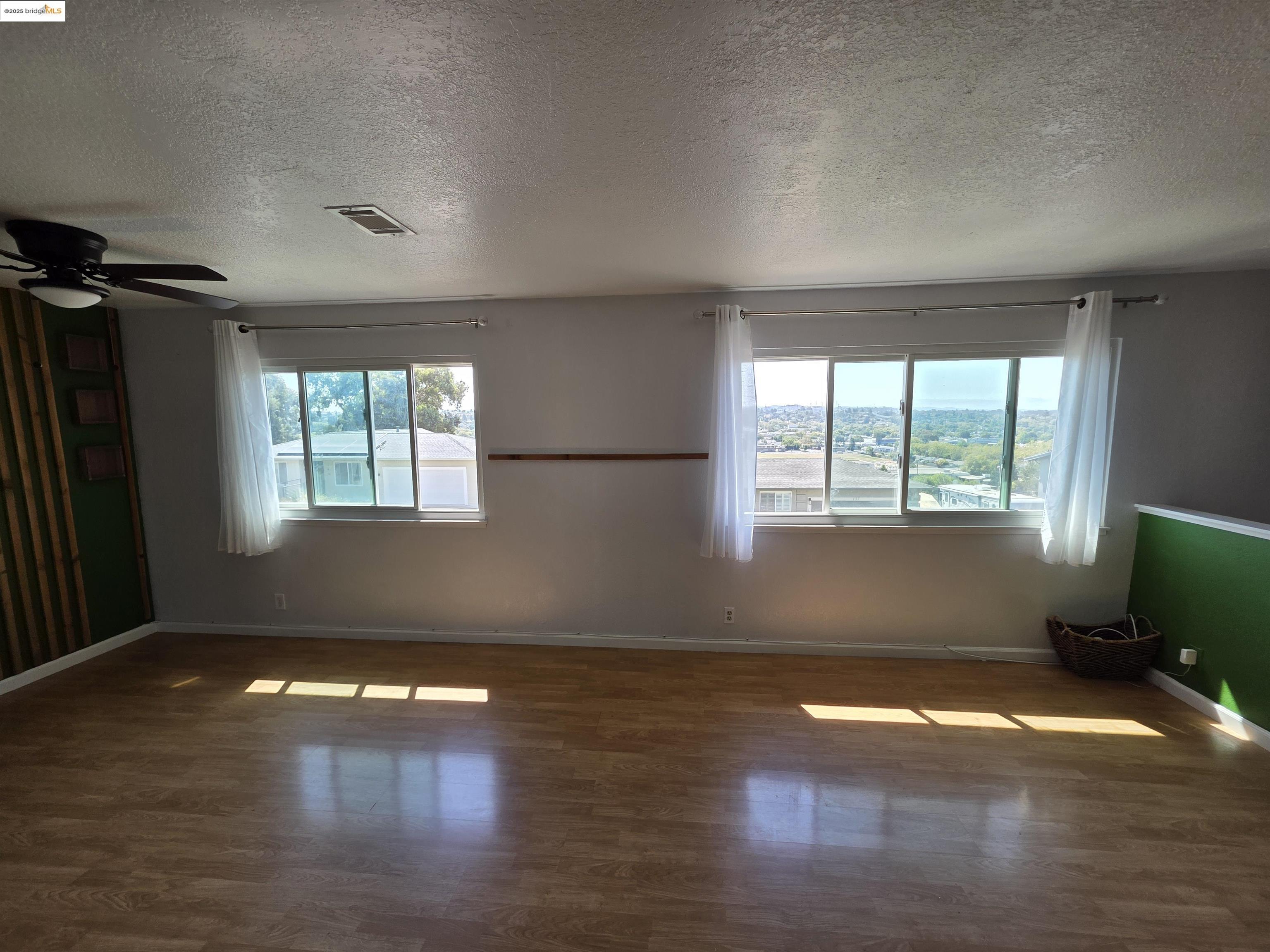 136 Evergreen Way Vallejo, CA 94591 - Photo 49 of 51 a view of empty room with wooden floor and fan