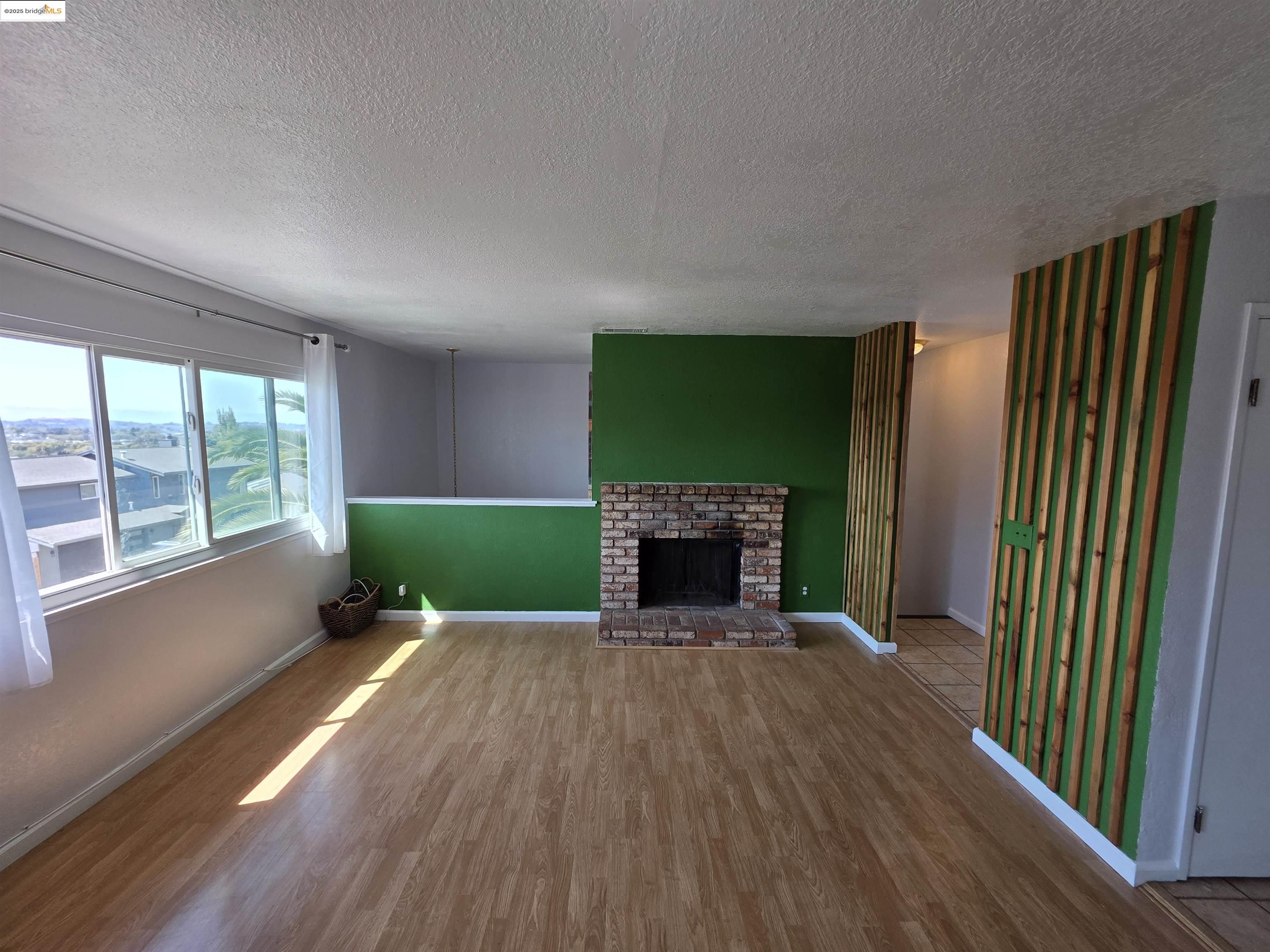 136 Evergreen Way Vallejo, CA 94591 - Photo 51 of 51 an empty room with wooden floor fireplace and windows