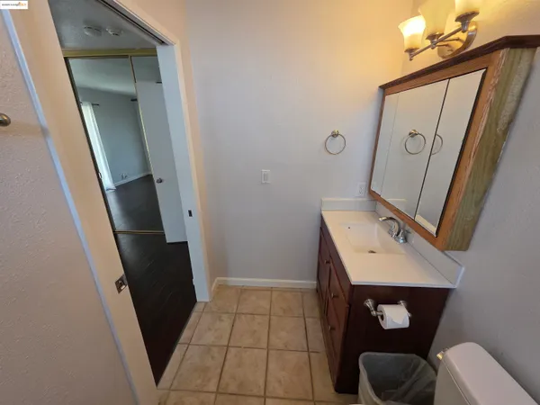 a view of bathroom with a sink and mirror