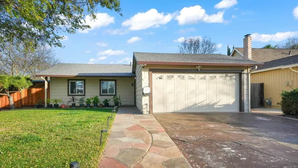 a view of a house with a porch and a yard