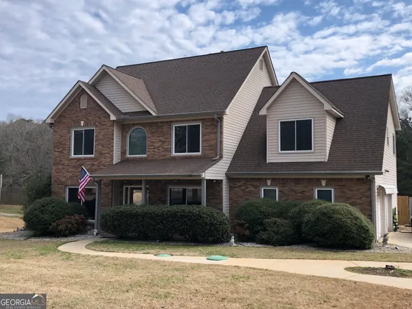 a front view of a house with a yard