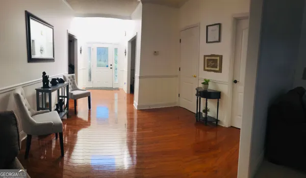 a view of a livingroom with furniture and hardwood floor