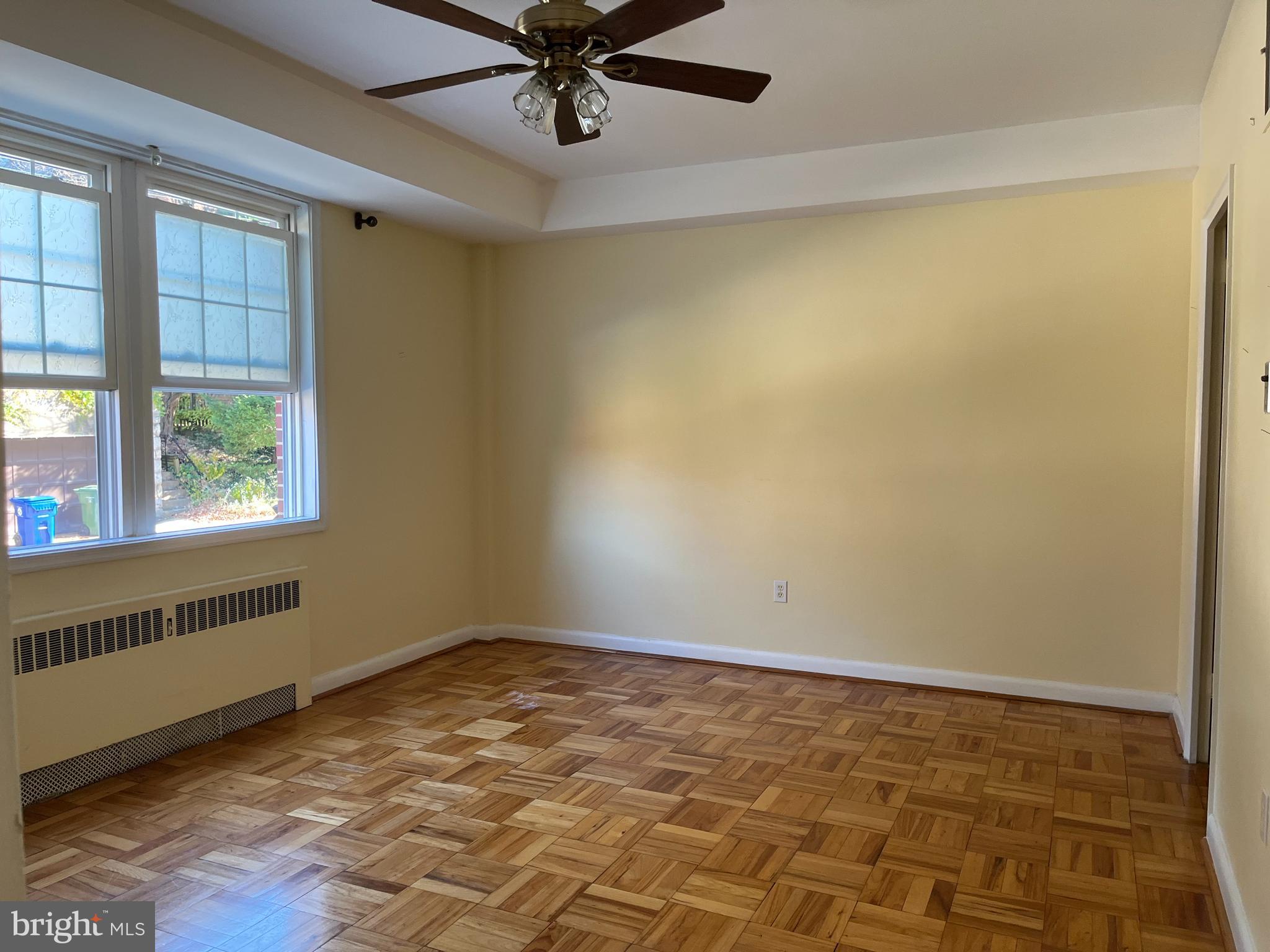 310 Ridgemede Road, Unit 207 Baltimore, MD 21210 - Photo 18 of 32 wooden floor in an empty room with a window