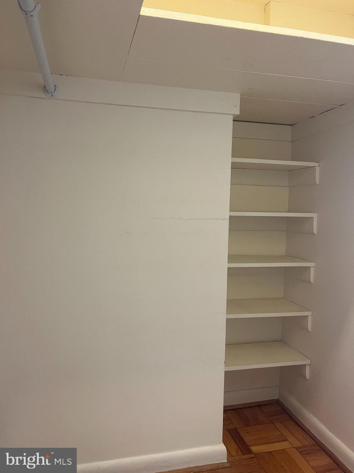 310 Ridgemede Road, Unit 207 Baltimore, MD 21210 - Photo 19 of 32 a view of walk in closet with empty racks