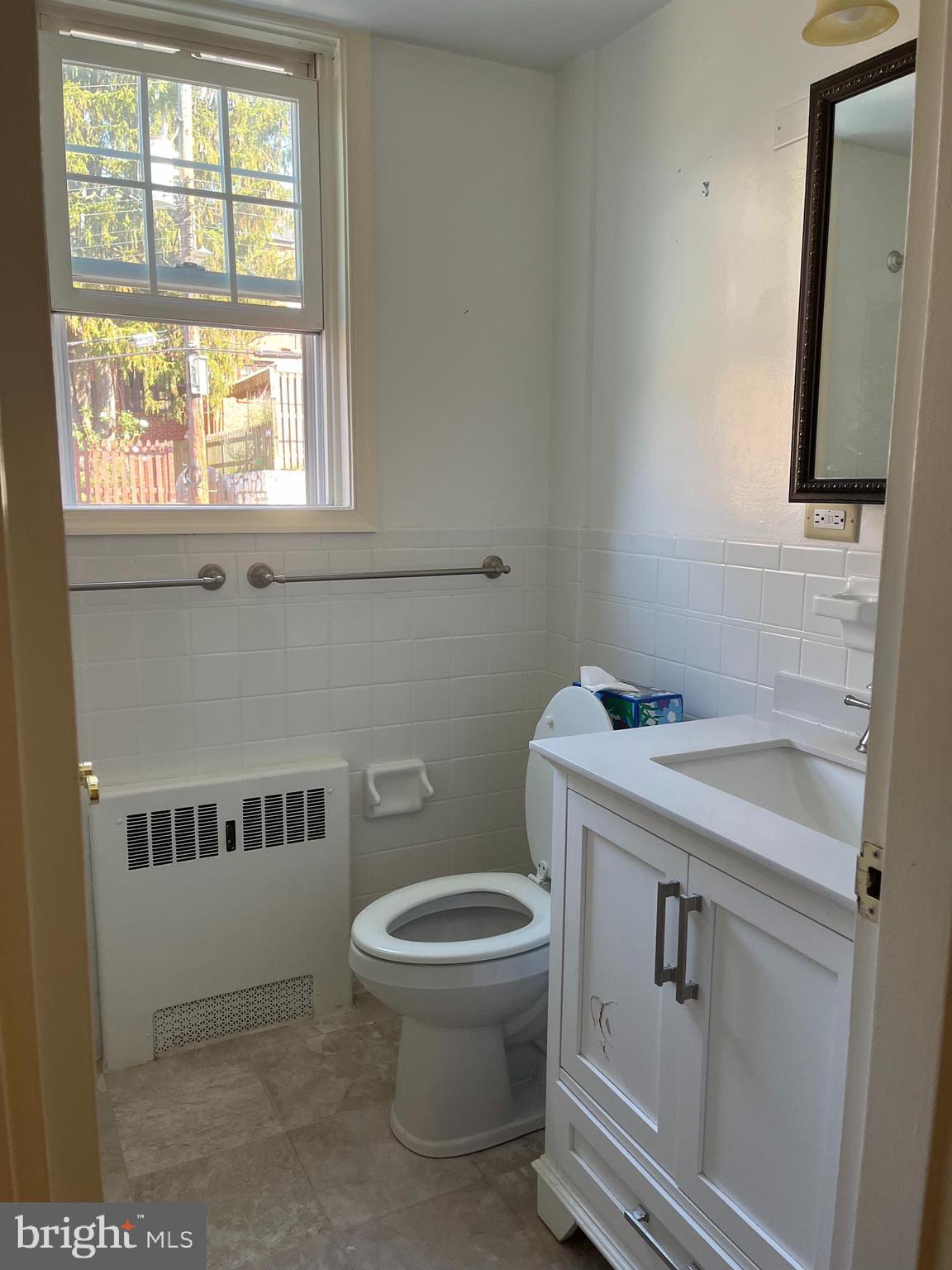310 Ridgemede Road, Unit 207 Baltimore, MD 21210 - Photo 22 of 32 a bathroom with a sink a toilet and a window
