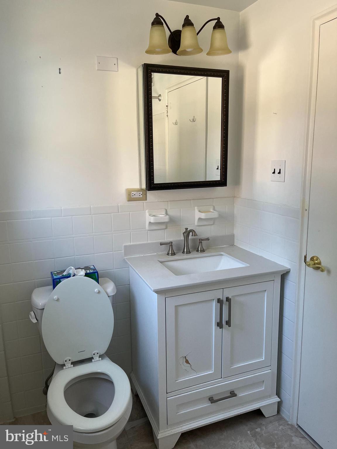 310 Ridgemede Road, Unit 207 Baltimore, MD 21210 - Photo 23 of 32 a bathroom with a toilet sink and mirror