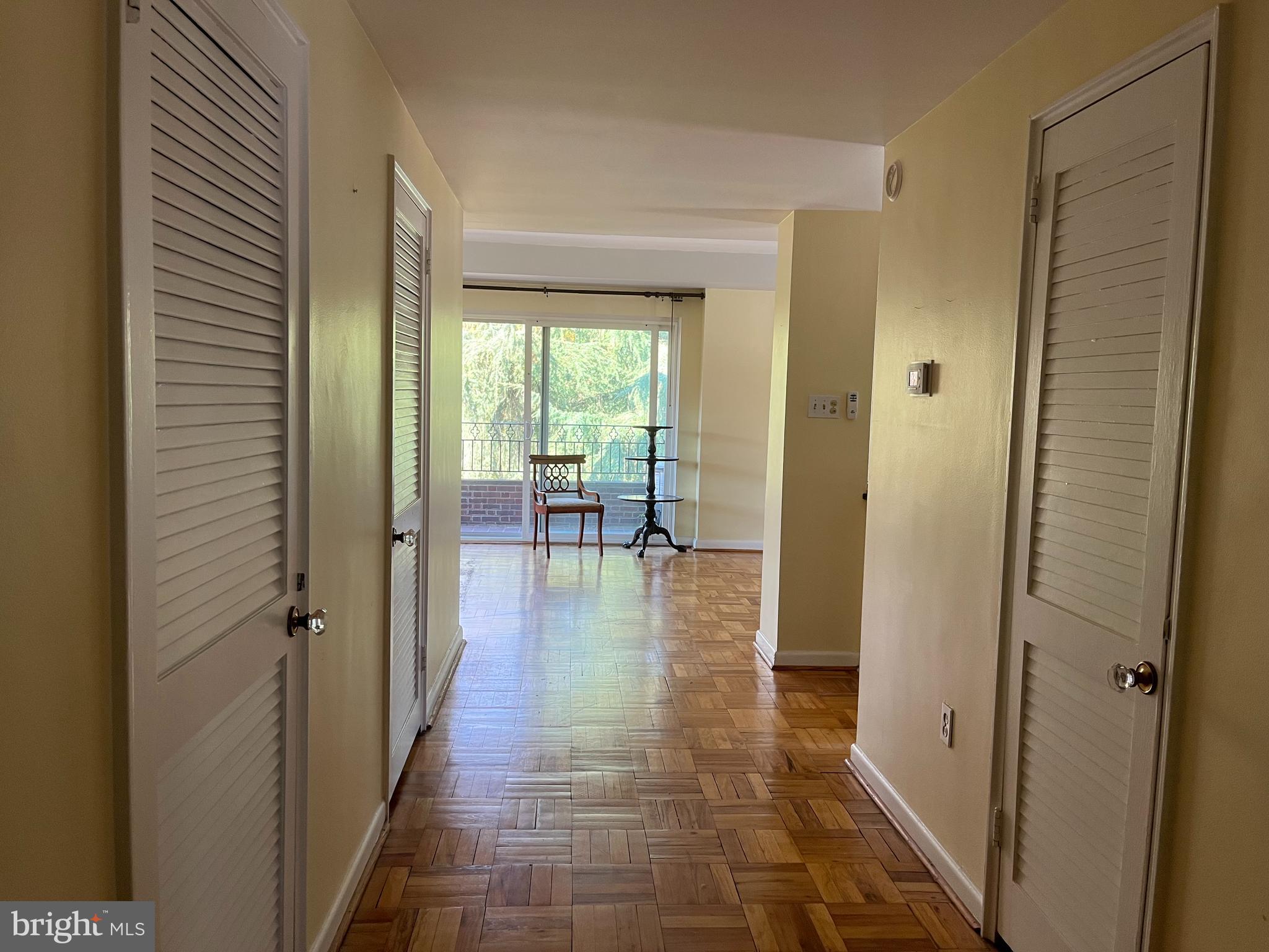 310 Ridgemede Road, Unit 207 Baltimore, MD 21210 - Photo 25 of 32 a hallway with wooden floor table and chairs