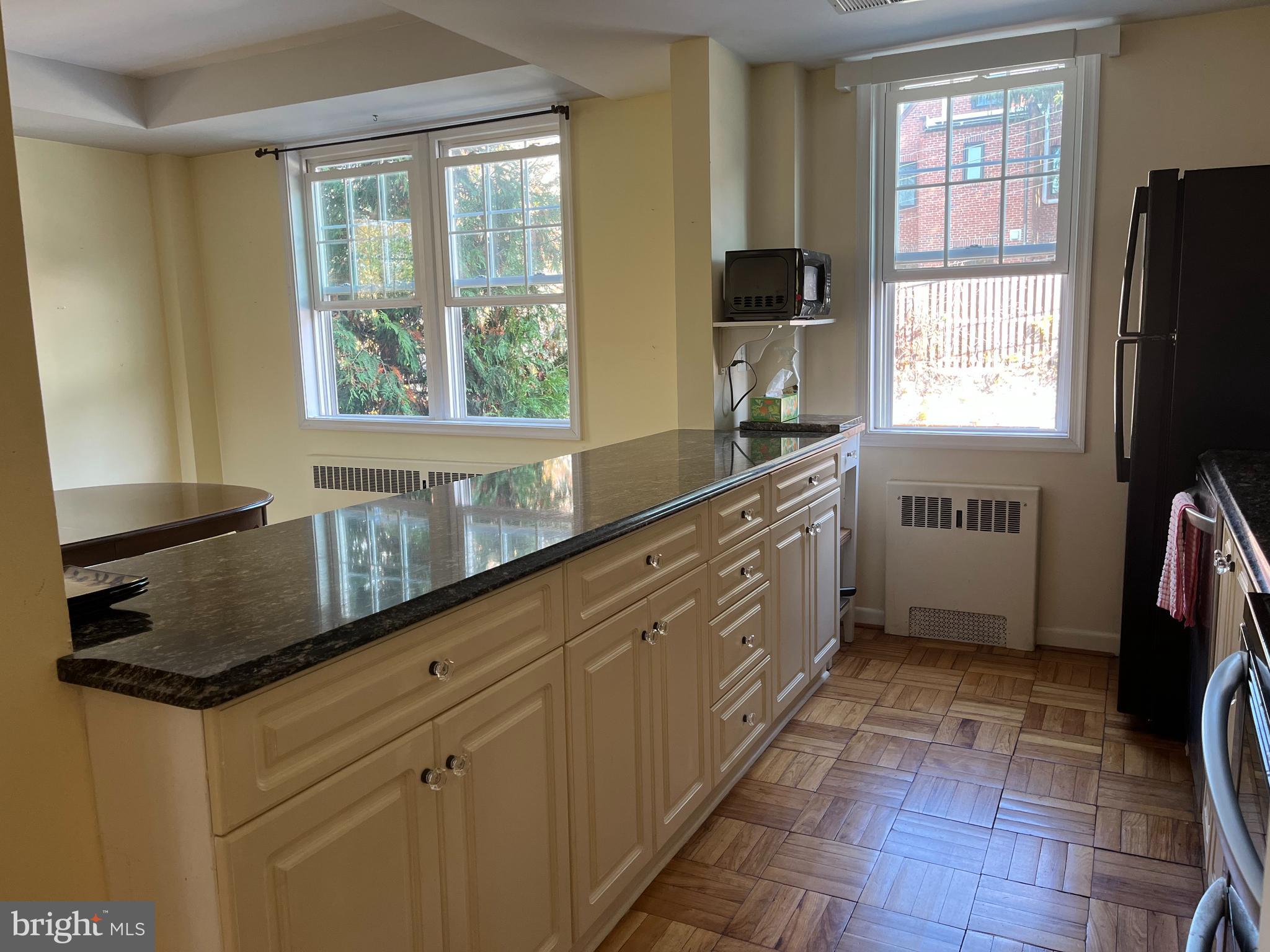 310 Ridgemede Road, Unit 207 Baltimore, MD 21210 - Photo 6 of 32 a kitchen with stainless steel appliances granite countertop a sink stove and cabinets