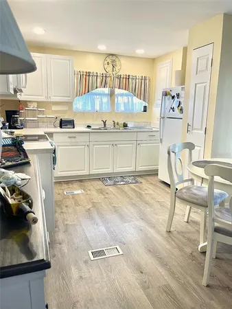 a kitchen with a sink a stove and a refrigerator