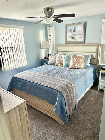 a bedroom with a bed and a painting on the wall